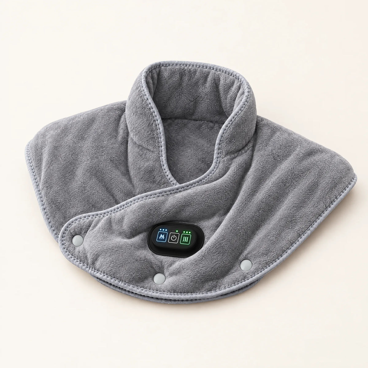 Coussin chauffant gris posé à plat, boîtier de commande au centre